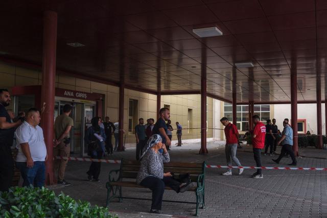 Relatives of injured people wait at Turgutlu state hospital after a gunman opened fire, wounding eleven people outside a high school before being detained shortly afterwards, in Turgutlu, an area west of the resort city of Izmir, on September 22, 2026. A teenager opened fire outside a high school in western Turkey on Tuesday, wounding 11 people before being detained by police, a minister said. The incident happened around 8:00 am (0500 GMT) in Turgutlu in Manisa province, near the western resort city of Izmir, the regional governor's office said. (Photo by Ilker ERAY / AFP)