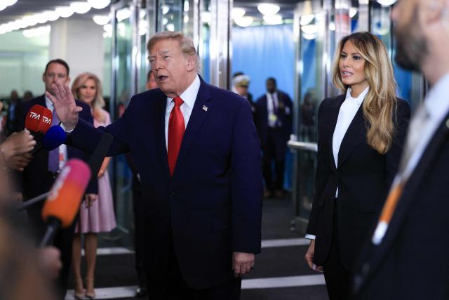 (L/R) US President Donald Trump speaks to the press as US First Lady Melania Trump looks on as they arrive during the 81st United Nations General Assembly at the United Nations Headquarters in New York, on September 22, 2026. (Photo by CHARLY TRIBALLEAU / AFP)