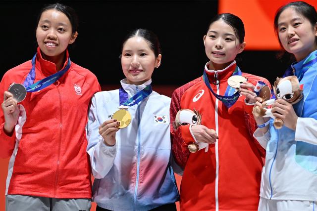 Bronze medalist Japan's Tamaki Terayama (2R) poses on the podium during the victory ceremony of the women's individual epee fencing event in the 2026 Asian Games at Aichi Sky Expo in Aichi Prefecture on September 22, 2026. (Photo by JIJI Press / AFP) / Japan OUT