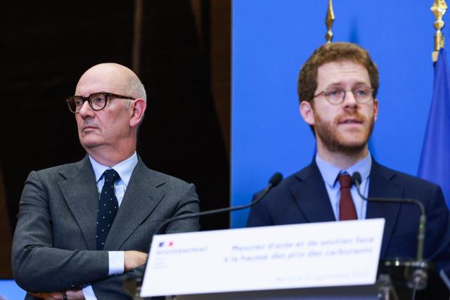 France's Economy, Finances and Industry Minister Roland Lescure looks on as Frances junior Minister for Public Accounts David Amiel speaks during a press conference on measures to support households facing rising fuel prices, at the Economy ministry (Bercy) in Paris on September 22, 2026. The announcement follows diesel prices reaching a new record above 2.39 euros per litre, with the government pledging to extend support for affected workers beyond September 30, 2026, without yet specifying the scope or cost of the measures. (Photo by Kenzo TRIBOUILLARD / AFP)