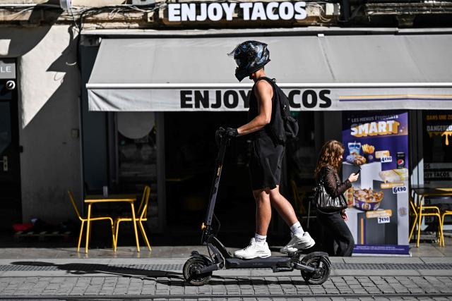 A man rides an electric scooter on a street of Montpellier, southern France on September 22, 2026. (Photo by Gabriel BOUYS / AFP)