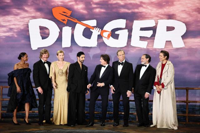 (L-R) Australian actress Sophie Wilde, US actor Jesse Plemons, German actress Sandra Hьller, British actor Riz Ahmed, US actor Tom Cruise, US actor John Goodman, US actor Michael Stuhlbarg and British actor Emma D’Arcy pose upon arrival for the global premiere of the film 'Digger' in Leicester Square in central London on September 22, 2026. (Photo by Henry Nicholls / AFP)