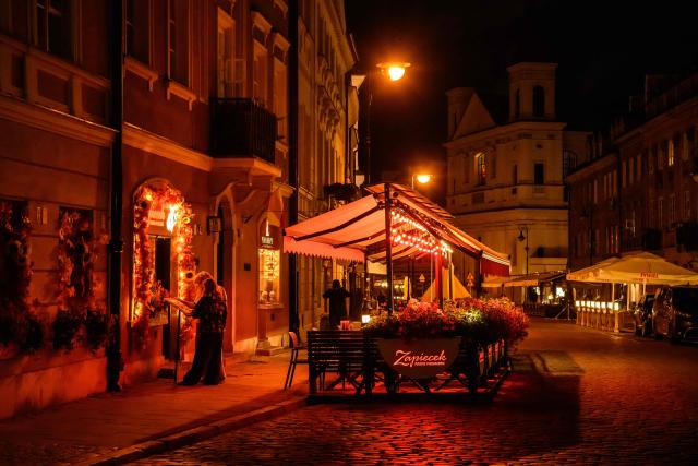 People check the menu of a restaurant in the Old Town in Warsaw on September 22, 2026. (Photo by Mladen ANTONOV / AFP)