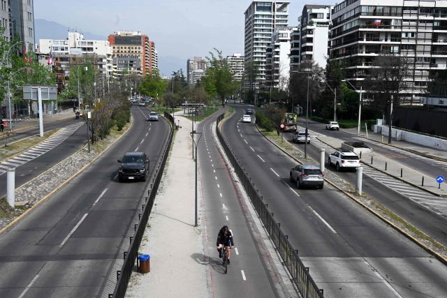 Vehicles travel along an avenue on World Car-Free Day in Santiago on September 22, 2026. (Photo by RODRIGO ARANGUA / AFP)