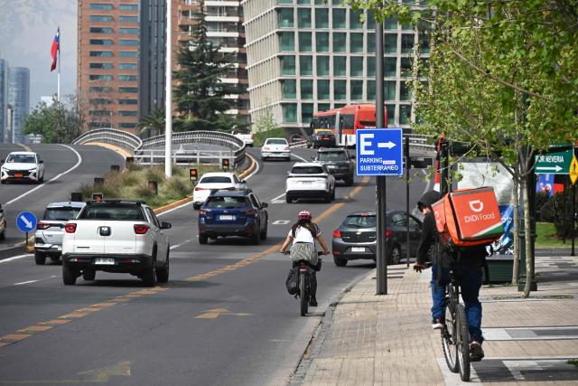 Vehicles travel along an avenue on World Car-Free Day in Santiago on September 22, 2026. (Photo by RODRIGO ARANGUA / AFP)