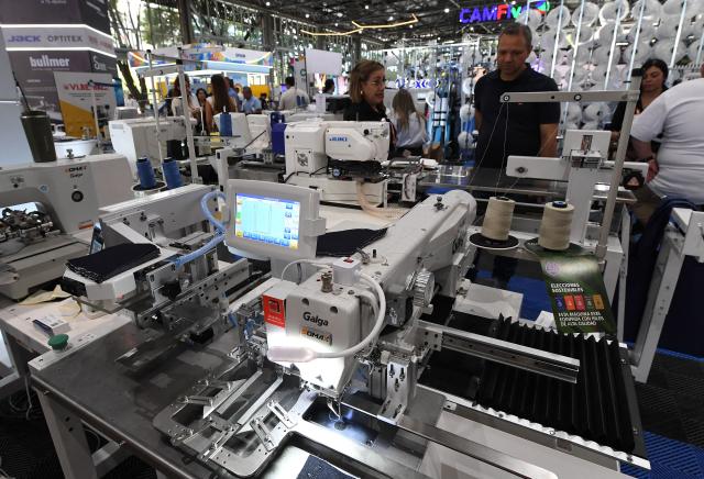 People look at textile machines during the Nextech textile trade show in Medellin, Colombia on September 22, 2026. (Photo by Jaime SALDARRIAGA / AFP)