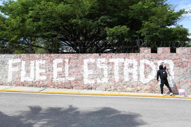 A demonstrator paints the slogan "It was the State" on a wall during a protest ahead of the 12th anniversary of the disappearance of the 43 Ayotzinapa students in Chilpancingo, Guerrero state, Mexico, on September 22, 2026. The 43 students from a teachers' college disappeared on September 26, 2014, while traveling by bus through the state of Guerrero to take part in a demonstration in Mexico City. (Photo by Eduardo Guerrero / AFP)