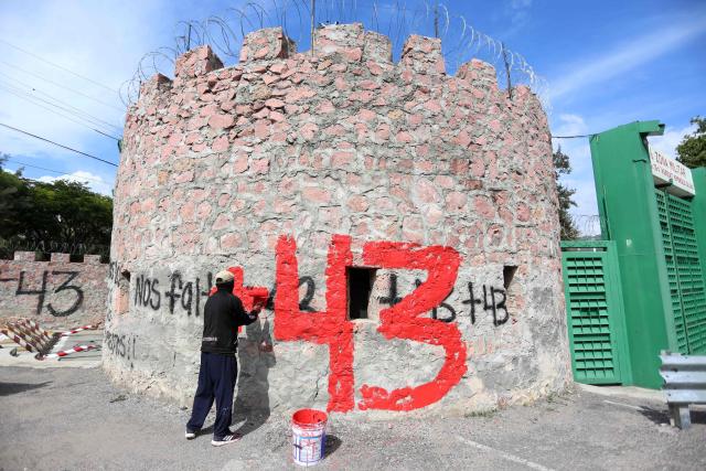 A demonstrator paints the number "43" on a wall during a protest ahead of the 12th anniversary of the disappearance of the 43 Ayotzinapa students in Chilpancingo, Guerrero state, Mexico, on September 22, 2026. The 43 students from a teachers' college disappeared on September 26, 2014, while traveling by bus through the state of Guerrero to take part in a demonstration in Mexico City. (Photo by Eduardo Guerrero / AFP)