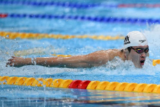 China's Xu Fang competes in a heat of the men's 100m butterfly swimming event during the 2026 Asian Games at the Tokyo Aquatics Centre in Tokyo on September 23, 2026. (Photo by ANDREW CABALLERO-REYNOLDS / AFP)