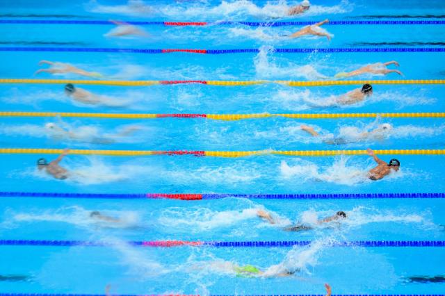 TOPSHOT - Swimmers compete in a heat of the men's 100m butterfly swimming event during the 2026 Asian Games at the Tokyo Aquatics Centre in Tokyo on September 23, 2026. (Photo by Yuichi YAMAZAKI / AFP)