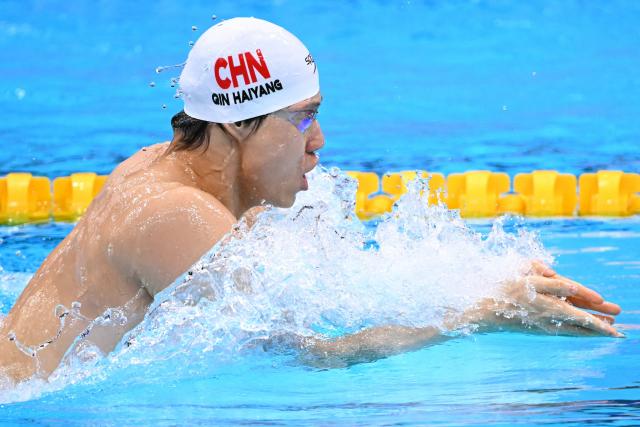 China's Qin Haiyang competes in a heat of the mixed 4 x 100m medley relay swimming event during the 2026 Asian Games at the Tokyo Aquatics Centre in Tokyo on September 23, 2026.  (Photo by Yuichi YAMAZAKI / AFP)