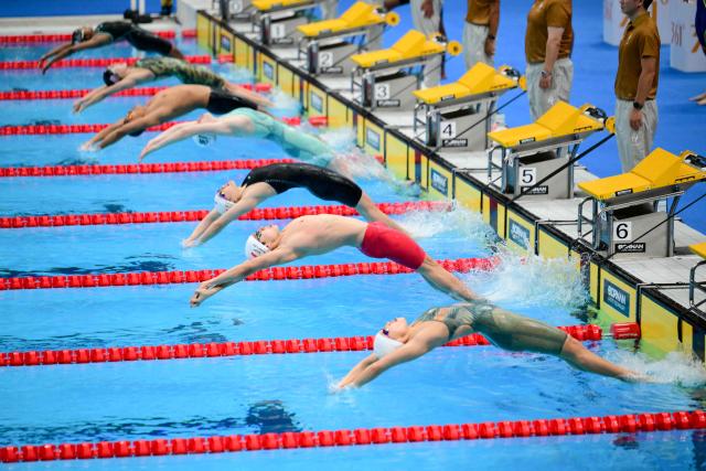 Swimmers compete in a heat of the mixed 4 x 100m medley relay swimming event during the 2026 Asian Games at the Tokyo Aquatics Centre in Tokyo on September 23, 2026.  (Photo by Yuichi YAMAZAKI / AFP)