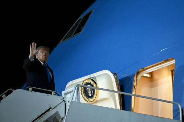 US President Donald Trump waves while boarding Air Force One at John F. Kennedy International Airport in New York on September 22, 2026. Trump is returning to the White House after addressing the United Nations General Assembly. (Photo by Brendan SMIALOWSKI / AFP)