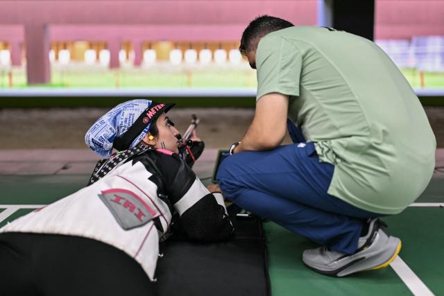 Iran's Shermineh Chehel Amirani talks with her coach in a shooting training session during the 2026 Asian Games at the Aichi Prefectural Genral Shooting Gallery in Toyota on September 23, 2026. (Photo by MOHD RASFAN / AFP)