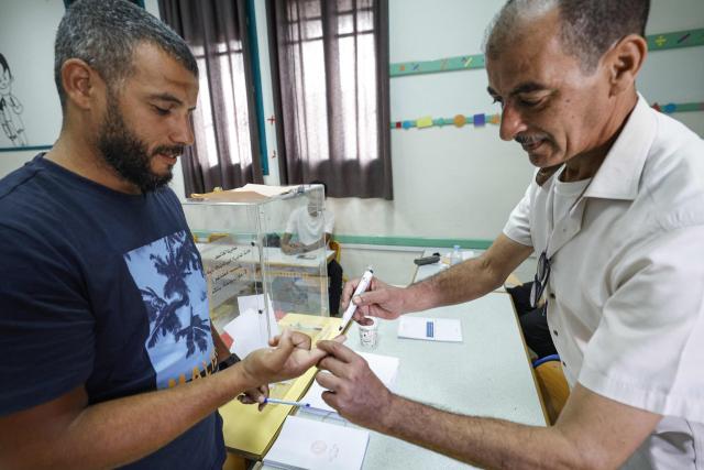 A man gets his finger marked after casting his ballot to vote during Morocco's legislative elections at a polling station inside a school at the Udayas neighborhood in Rabat on September 23, 2026. Moroccans headed to the polls on September 23 to elect a new parliament, with voters focused on the cost of living, employment and inequality while parties stand challenged by distrust. Polling stations opened at 08:00 am (0800 GMT) and were set to close at 07:00 pm, with preliminary results to be announced later at night. (Photo by Abdel Majid BZIOUAT / AFP)