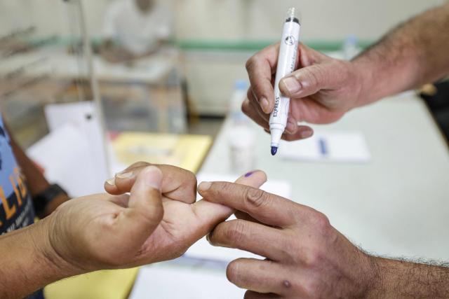 A man gets his finger marked after casting his ballot to vote during Morocco's legislative elections at a polling station inside a school at the Udayas neighborhood in Rabat on September 23, 2026. Moroccans headed to the polls on September 23 to elect a new parliament, with voters focused on the cost of living, employment and inequality while parties stand challenged by distrust. Polling stations opened at 08:00 am (0800 GMT) and were set to close at 07:00 pm, with preliminary results to be announced later at night. (Photo by Abdel Majid BZIOUAT / AFP)