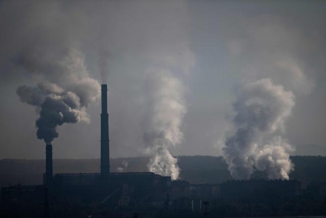This photograph taken on September 18, 2026, shows a smoke rising from the coal-fired Brikel TPP near Galabovo, Central Bulgaria. As Eastern Europe's power sector has taken a hit from a record drought, Bulgaria has benefitted from a surge in solar-powered battery projects across the country. Around a hundred large battery energy storage system (BESS) sites are now operating, most of them built in the past two years. (Photo by Nikolay DOYCHINOV / AFP)