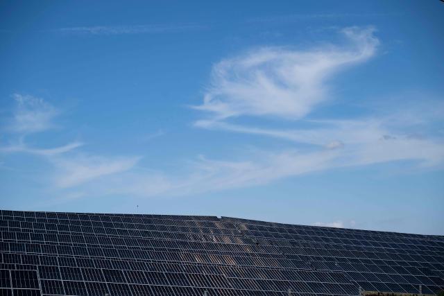 This photograph taken on September 18, 2026, shows Sunterra Re's photovoltaic plant located next to to Maritsa East 3 TPP near Galabovo, central Bulgaria. As Eastern Europe's power sector has taken a hit from a record drought, Bulgaria has benefitted from a surge in solar-powered battery projects across the country. Around a hundred large battery energy storage system (BESS) sites are now operating, most of them built in the past two years. (Photo by Nikolay DOYCHINOV / AFP)