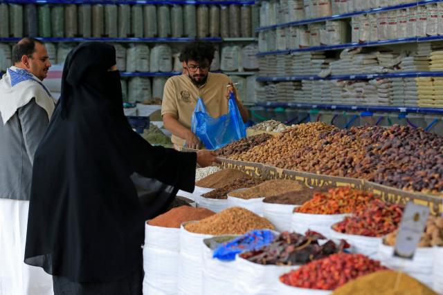 Visitors gather at a stall during an exhibition organised to promote locally grown agricultural produce, in Sanaa on September 23, 2026. (Photo by Mohammed HUWAIS / AFP)