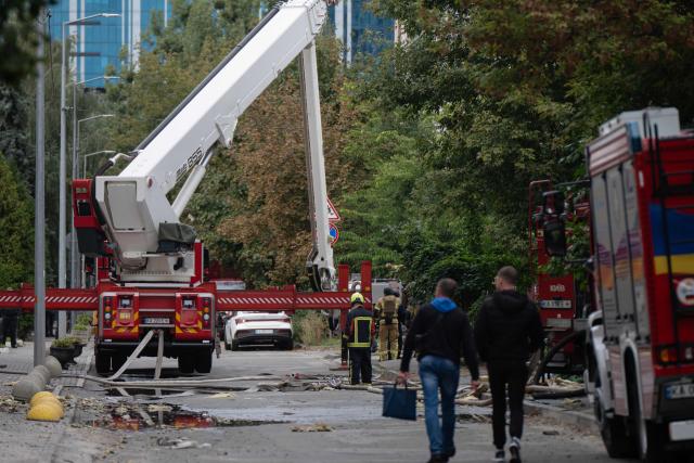 Firefighters extinguish a fire at a building damaged following a drone strike in Kyiv on September 23, 2026, amid the Russian invasion of Ukraine. Ukraine on September 23, 2026 accused Russia of increasing its targeting of civilian transport infrastructure after renewed attacks on petrol stations, shipping and railways left at least two dead. (Photo by Genya SAVILOV / AFP)