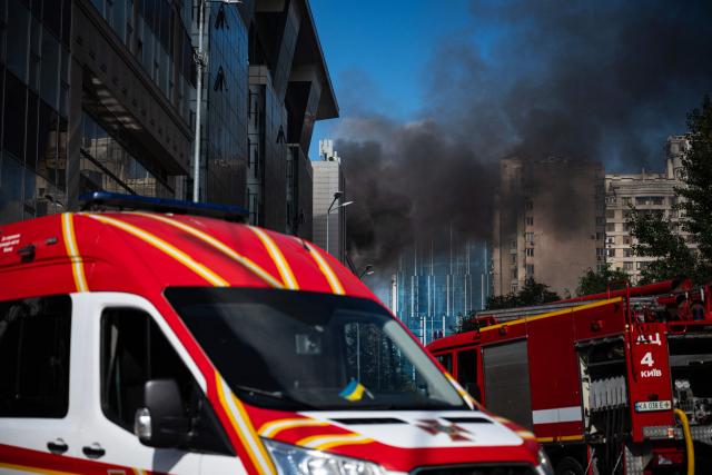 Firefighters extinguish a fire at a building damaged following a drone strike in Kyiv on September 23, 2026, amid the Russian invasion of Ukraine. Ukraine on September 23, 2026 accused Russia of increasing its targeting of civilian transport infrastructure after renewed attacks on petrol stations, shipping and railways left at least two dead. (Photo by Genya SAVILOV / AFP)