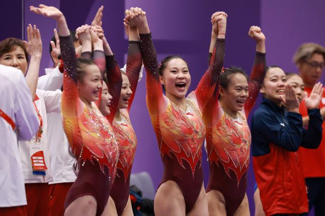 China's gymnasts and team members celebrate winning the women's artistic gymnastics team final during the 2026 Asian Games at the Nagoya City General Gymnasium in Nagoya, Aichi prefecture on September 23, 2026. (Photo by DAVID GRAY / AFP)