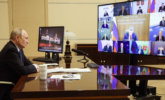 In this pool photograph distributed by the Russian state agency Sputnik, Russia's President Vladimir Putin chairs a meeting with government members via a video link in Moscow on September 23, 2026. (Photo by Vyacheslav PROKOFYEV / POOL / AFP)