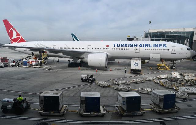 (FILES) Baggage trucks are seen by a Turkish airlines Boeing 777 at Los Angeles International Airport (LAX) on January 11, 2023. Turkish Airlines said on September 23, 2026 it was to buy 150 jets from Boeing that would be scheduled for delivery between 2033 and 2037. The Turkish national carrier said it had "decided to purchase a total of 150 aircraft from Boeing" consisting of a firm order for 100 Boeing 737 MAX jets and an option for 50 more. (Photo by Daniel SLIM / AFP)