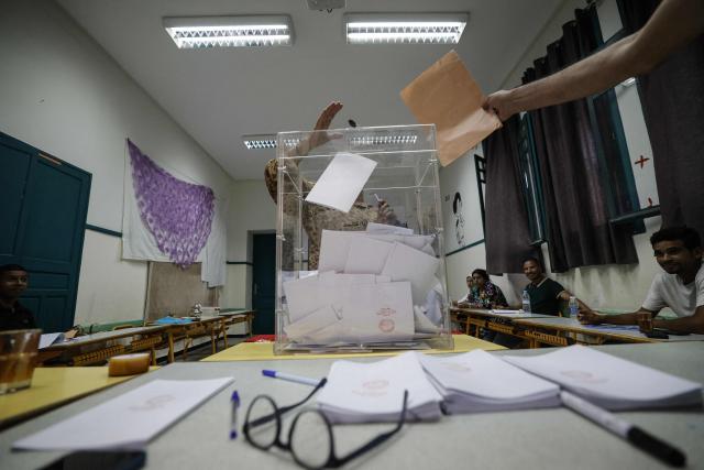 A woman casts her ballot during Morocco’s legislative elections at a polling station set up inside a school in the Oudayas neighbourhood of Rabat on September 23, 2026. Moroccans cast their ballots for a new parliament on September 23 with unemployment and inequality front of mind, even as some expressed a lack of trust in the parties in contention. Nearly 16 million Moroccans have registered to elect 395 members of the House of Representatives. (Photo by Abdel Majid BZIOUAT / AFP)