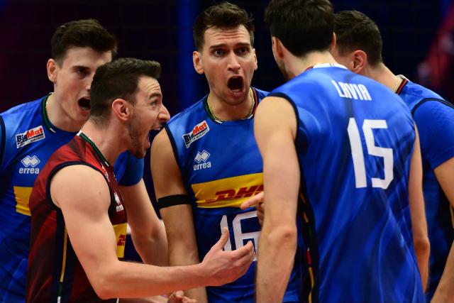 Italy’s Yuri Romano (C) celebrates with teammates after scoring during the CEV EuroVolley 2026 men's quarterfinal volleyball match between Italy and Finland at the Palavela in Turin on September 23, 2026. (Photo by Marco BERTORELLO / AFP)