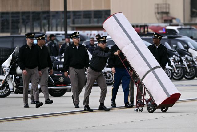Members of the US Army moves a red carpet into position as prepartions take place before US President Donald Trump greets Chinese President Xi Jinping upon his arrival at Joint Base Andrews in Maryland on September 23, 2026. Xi is visiting the United States from September 23 to 25. (Photo by Brendan SMIALOWSKI / AFP)