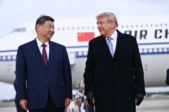 US President Donald Trump greets Chinese President Xi Jinping upon arrival at Joint Base Andrews in Maryland on September 23, 2026. Xi is visiting the United States from September 23 to 25. (Photo by Brendan SMIALOWSKI / AFP)