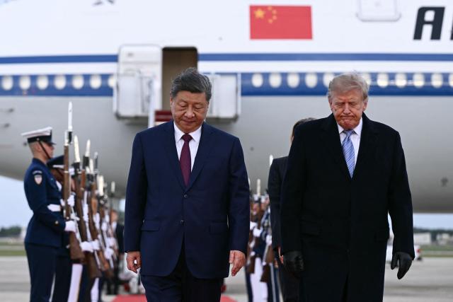 US President Donald Trump greets Chinese President Xi Jinping upon arrival at Joint Base Andrews in Maryland on September 23, 2026. Xi is visiting the United States from September 23 to 25. (Photo by Brendan SMIALOWSKI / AFP)