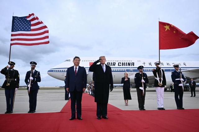 US President Donald Trump salutes as he greets Chinese President Xi Jinping upon arrival at Joint Base Andrews in Maryland on September 23, 2026. Xi is visiting the United States from September 23 to 25. (Photo by Brendan SMIALOWSKI / AFP)