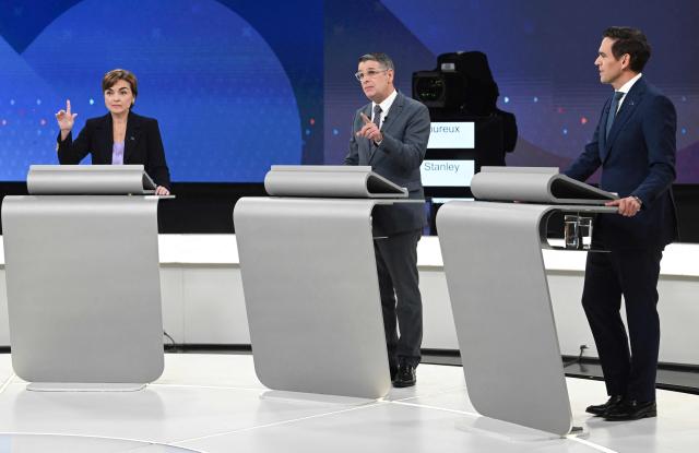 (From L) Leader of the Coalition Avenir Quebec (CAQ) Christine Frechette and Leader of the Conservative Party of Quebec (PCQ) Eric Duhaime gesture as Leader of the Quebec Liberal Party (PLQ) Charles Milliard speaks during the third and final televised Quebec election debate in Montreal, Quebec, Canada on September 23, 2026. Quebec voters will cast their vote on October 5. (Photo by Graham Hughes / POOL / AFP)