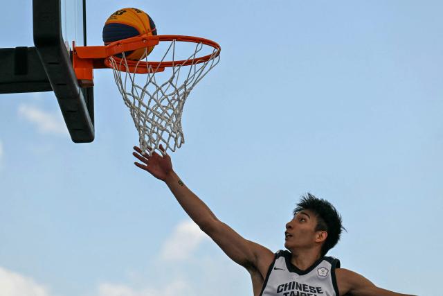 Taiwan's Chang Chun-sheng lays up the ball during the men's 3x3 basketball game between Taiwan and Malaysia at the 2026 Asian Games in Nagoya on September 24, 2026. (Photo by MOHD RASFAN / AFP)