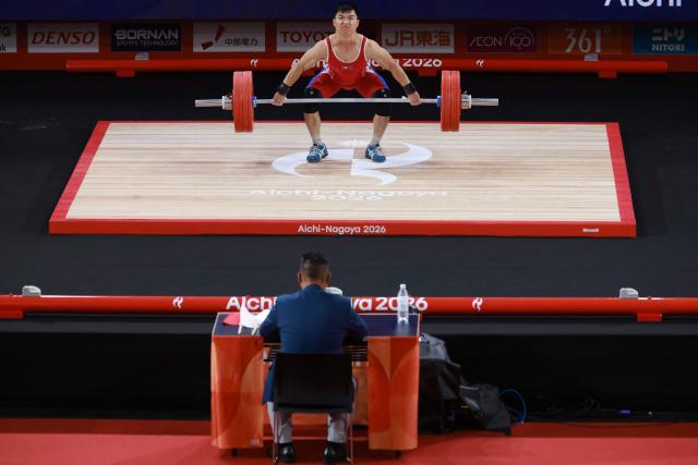 North Korea's Pang Un Chol competes in the men's 60kg weightlifting final at the 2026 Asian Games in Nagoya on September 24, 2026. (Photo by DAVID GRAY / AFP)