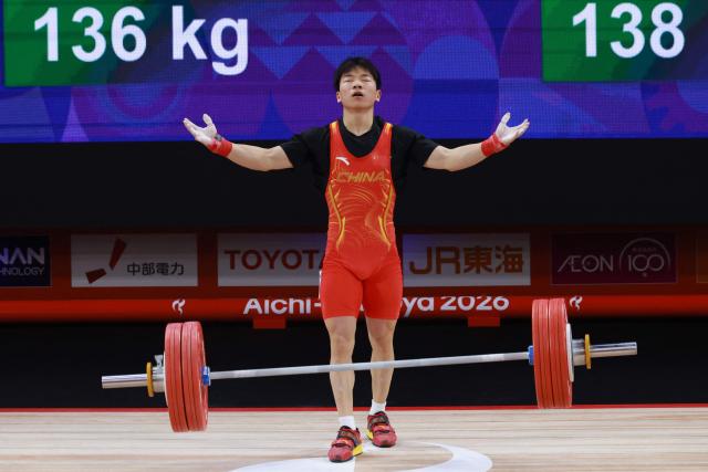 China's Yang Yang celebrates as he competes in the men's 60kg weightlifting final at the 2026 Asian Games in Nagoya on September 24, 2026. (Photo by DAVID GRAY / AFP)