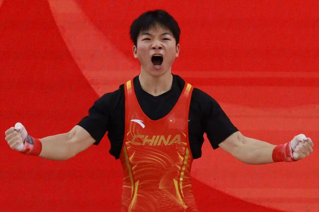 China's Yang Yang celebrates as he competes in the men's 60kg weightlifting final at the 2026 Asian Games in Nagoya on September 24, 2026. (Photo by DAVID GRAY / AFP)