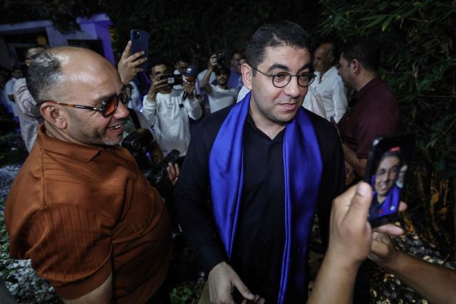 Morocco's Minister of Youth, Culture and Communication and member of the Authenticity and Modernity Party (PAM), Mohamed Mehdi Bensaid (R), celebrates with party members after the announcement of the provisional results of the legislative elections late on September 23, 2026. Morocco's centre-right Authenticity and Modernity Party (PAM), which is part of the kingdom's ruling coalition, came out ahead in September 23's parliamentary election after winning 97 out of 395 seats, according to provisional results. (Photo by Abdel Majid BZIOUAT / AFP)