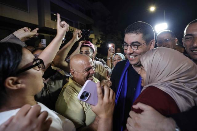 Morocco's Minister of Youth, Culture and Communication and member of the Authenticity and Modernity Party (PAM), Mohamed Mehdi Bensaid (2nd R), celebrates with party members after the announcement of the provisional results of the legislative elections in the early hours of September 24, 2026. Morocco's centre-right Authenticity and Modernity Party (PAM), which is part of the kingdom's ruling coalition, came out ahead in September 23's parliamentary election after winning 97 out of 395 seats, according to provisional results. (Photo by Abdel Majid BZIOUAT / AFP)