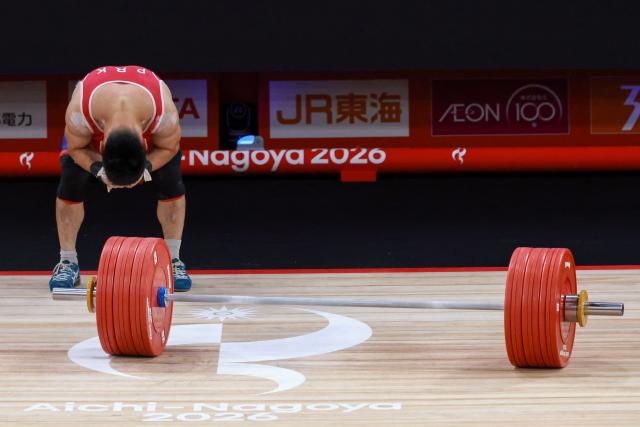 North Korea's Pang Un Chol reacts as he fails to make a lift in the men's 60kg weightlifting final at the 2026 Asian Games in Nagoya on September 24, 2026. (Photo by DAVID GRAY / AFP)