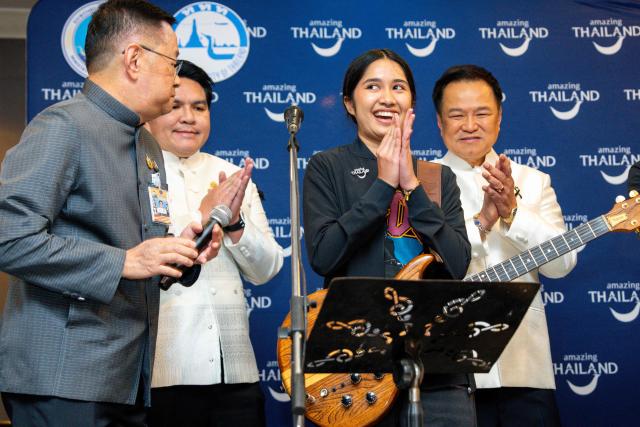 This photo taken on July 14, 2026 shows Thai musician Rattikarn "Nene Royal" Amloy (2nd R), 16, reacting next to Thailand's Prime Minister Anutin Charnvirakul (R) at Government House in Bangkok. A 16-year-old Thai rock singer and guitarist who has performed with the prime minister and Linkin Park won a top US television talent show on September 24, 2026, sparking celebrations back home. (Photo by Arnun Chonmahatrakool / THAI NEWS PIX / AFP)