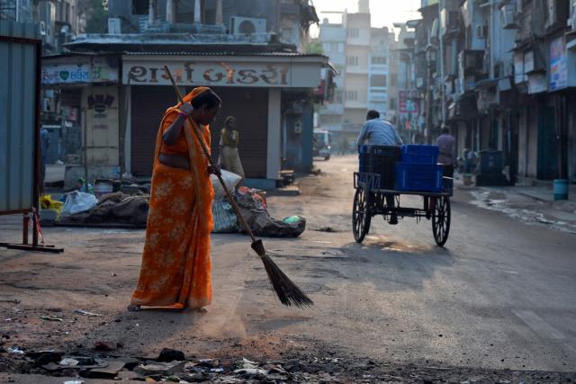 A sweeper brooms a street in Ahmedabad on September 24, 2026. (Photo by Shammi MEHRA / AFP)