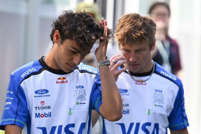 Racing Bulls' British driver Arvid Lindblad and Racing Bulls' New Zealand driver Liam Lawson arrive in the paddock for the first practice session ahead of the Formula One Azerbaijan Grand Prix at the Baku City Circuit in Baku on September 24, 2026. (Photo by Igor IVANKO / AFP)