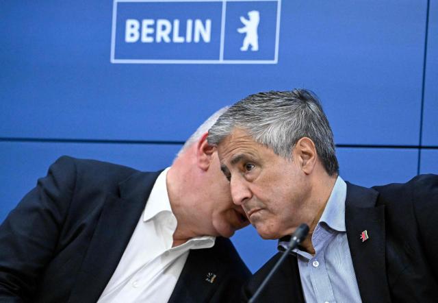 Berlin's outgoing governing mayor Kai Wegner (L) and sports official and Berlin's Olymic Commissioner Kaweh Niroomand chat during a press conference on the German capital's bid to host Olympic Games in Berlin on September 24, 2026. Berlin has withdrawn from the race to be part of Germany's upcoming summer Olympics bid, leaving just Munich and the Rhine/Ruhr region as potential hosts. On Saturday, September 26, 2026, the German Olympic Committee (DOSB) will make a call on a preferred region as part of a bid to the International Olympic Committee to host one of the 2036, 2040 and 2044 Summer Games. Berlin was one of the four German regions initially in the race but decided to withdraw. (Photo by Tobias SCHWARZ / AFP)