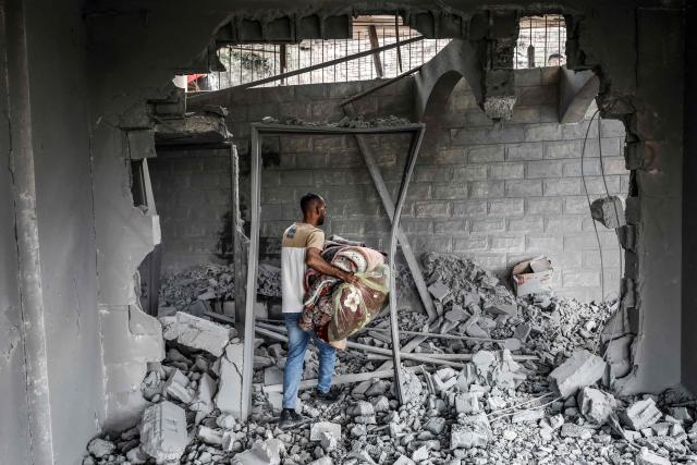 A man collects belongings from the rubble of the home of Palestinian prisoner Dawas Hassoun after it was demolished by the Israeli army in the Palestinian village of Beit Imrin, in the Israeli-occupied West Bank, on September 24, 2026. Hassoun is accused by Israeli authorities of carrying out a car-ramming attack in March 2026 that killed an Israeli settler. (Photo by Mohammad MANSOUR / AFP)