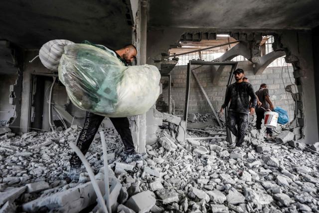 Men collect belongings from the rubble of the home of Palestinian prisoner Dawas Hassoun after it was demolished by the Israeli army in the Palestinian village of Beit Imrin, in the Israeli-occupied West Bank, on September 24, 2026. Hassoun is accused by Israeli authorities of carrying out a car-ramming attack in March 2026 that killed an Israeli settler. (Photo by Mohammad MANSOUR / AFP)
