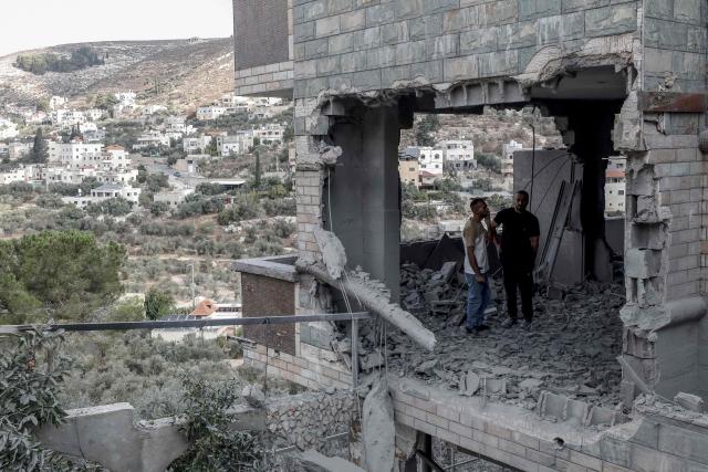 Men assess the damage after the home of Palestinian prisoner Dawas Hassoun was demolished by the Israeli army in the Palestinian village of Beit Imrin, in the Israeli-occupied West Bank, on September 24, 2026. Hassoun is accused by Israeli authorities of carrying out a car-ramming attack in March 2026 that killed an Israeli settler. (Photo by Mohammad MANSOUR / AFP)