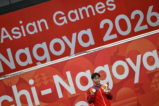 Gold medallist and world record holder Japan's Shin Ohashi celebrates on the podium during the victory ceremony of the men's 200m breaststroke swimming event during the 2026 Asian Games at the Tokyo Aquatics Centre in Tokyo on September 24, 2026. (Photo by ANDREW CABALLERO-REYNOLDS / AFP)